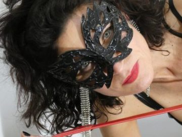 A close up of Mistress' face wearing a mask